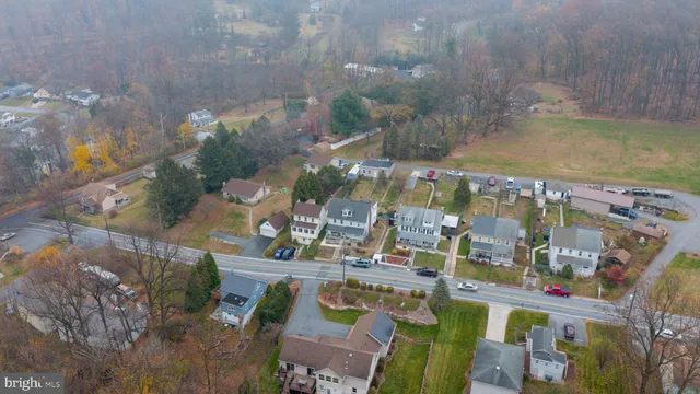 a view of house with backyard and outdoor seating