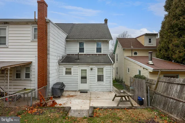 a building outdoor space with patio furniture and potted plants