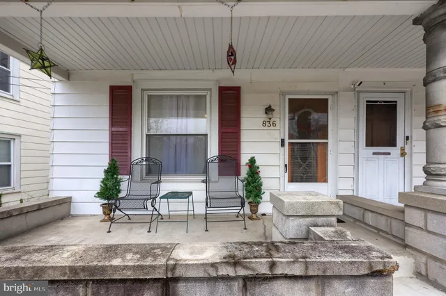 a view of a livingroom with workspace and a flat screen tv