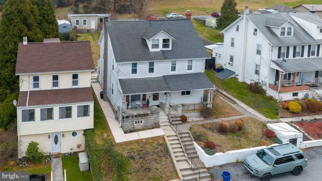 an aerial view of a house with a yard