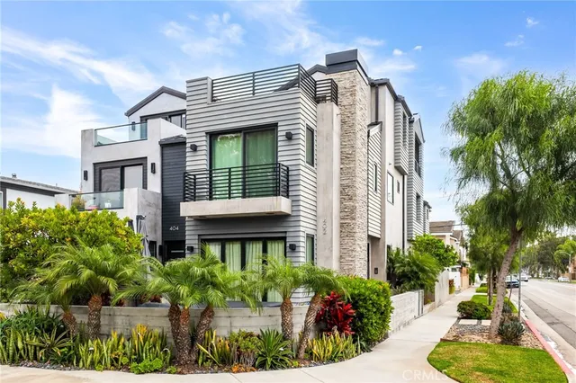 a front view of a house with a yard and potted plants