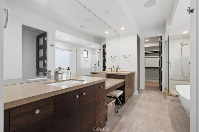 a spacious bathroom with a shower a sink and a mirror