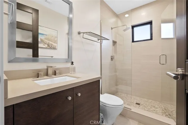 a bathroom with a double vanity sink toilet and shower