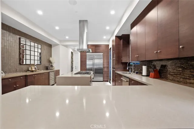 a kitchen with stainless steel appliances a sink a stove and a refrigerator