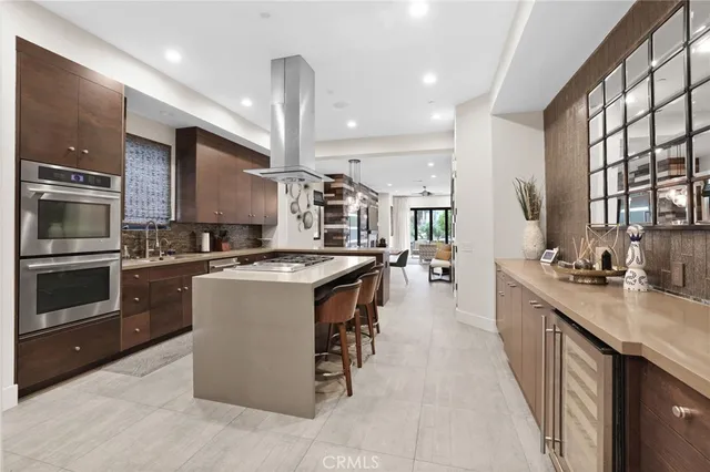 a large kitchen with stainless steel appliances kitchen island granite countertop a large counter top cabinets and a sink