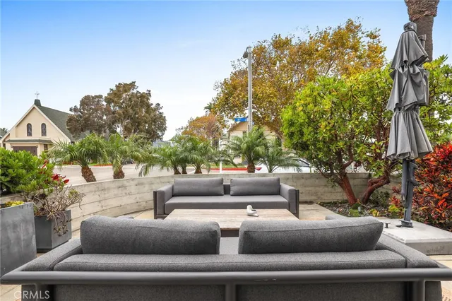 a view of patio with couches and a fire pit