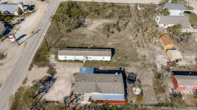 an aerial view of a house with a yard