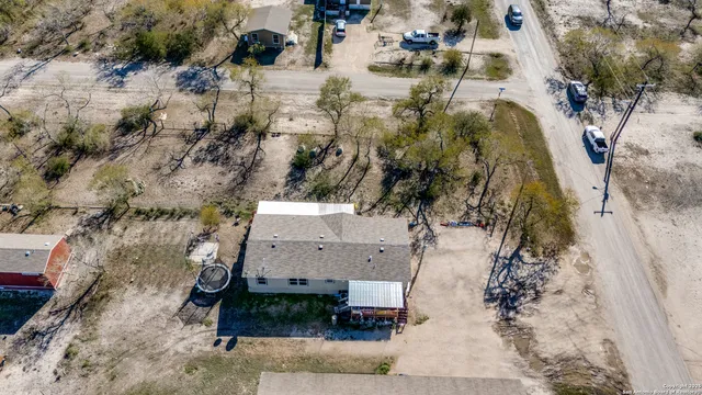 an aerial view of a house with a yard