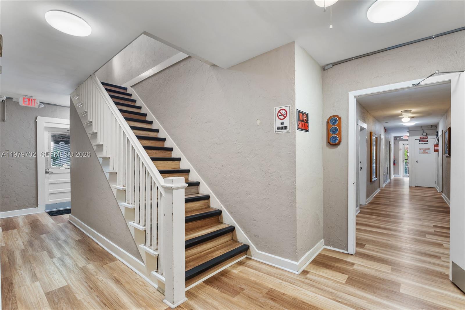 3409 South Le Jeune Road Coral Gables, FL 33134 - Photo 33 of 53 a view of a hallway with wooden floor and stairs
