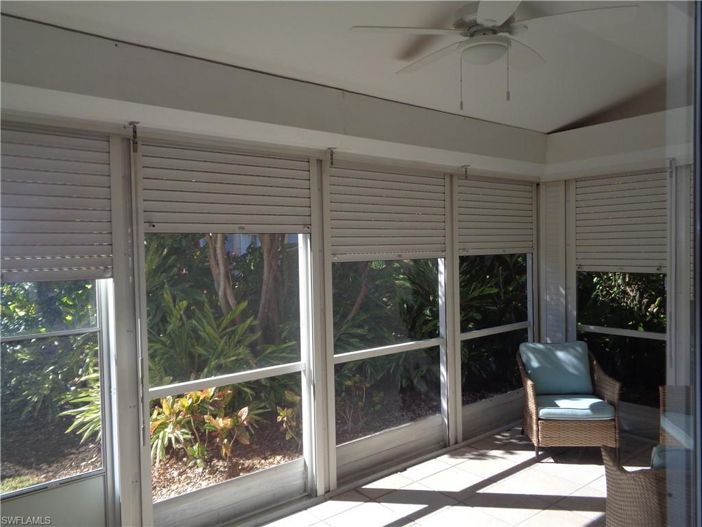 264 Perignon Place, Unit 113 Naples, FL 34119 - Photo 13 of 15 a view of a porch with a table and chairs