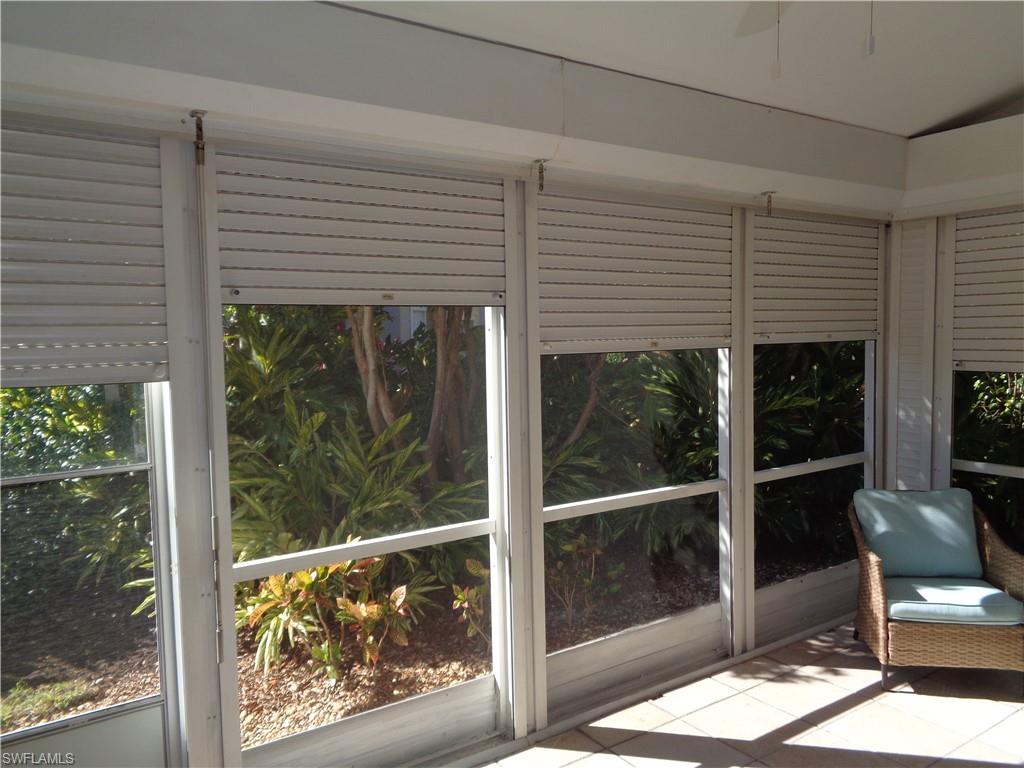 264 Perignon Place, Unit 113 Naples, FL 34119 - Photo 15 of 15 a front view of a house with large windows