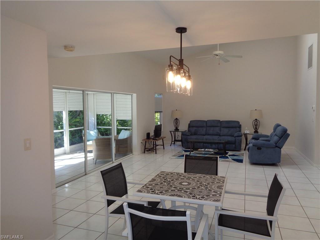 264 Perignon Place, Unit 113 Naples, FL 34119 - Photo 3 of 15 a living room with furniture and a chandelier