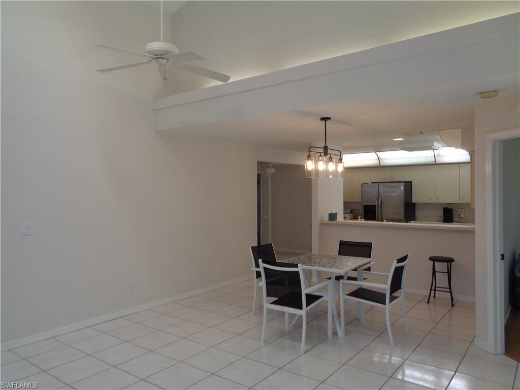 264 Perignon Place, Unit 113 Naples, FL 34119 - Photo 5 of 15 a view of a dining room with furniture and chandelier