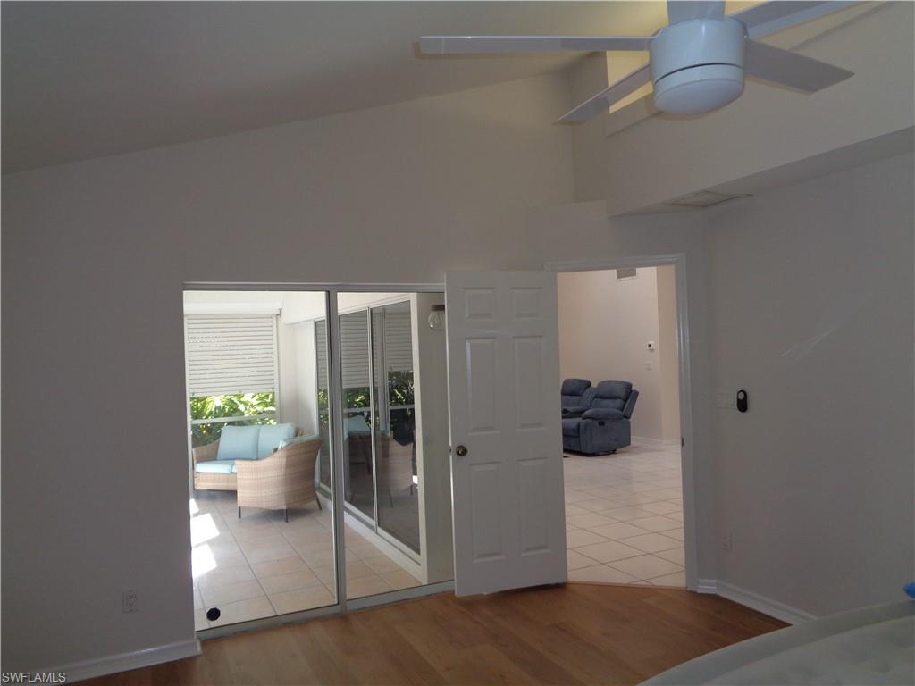 264 Perignon Place, Unit 113 Naples, FL 34119 - Photo 8 of 15 a view of a hallway to dining room and wooden floor