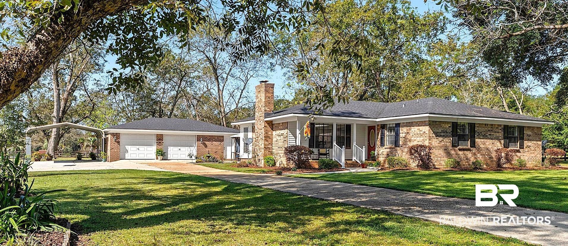 8090 Murray Hill Road Irvington, AL 36544 - Photo 1 of 40 Ranch-style house with brick siding, a chimney, and a front lawn