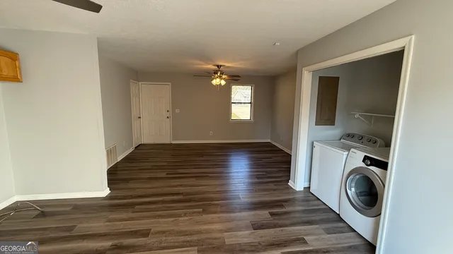 a view of a hallway with wooden floor and a window
