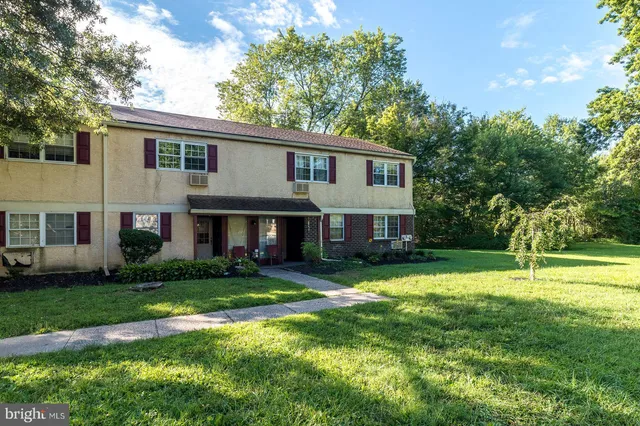 a view of a house with a yard and plants