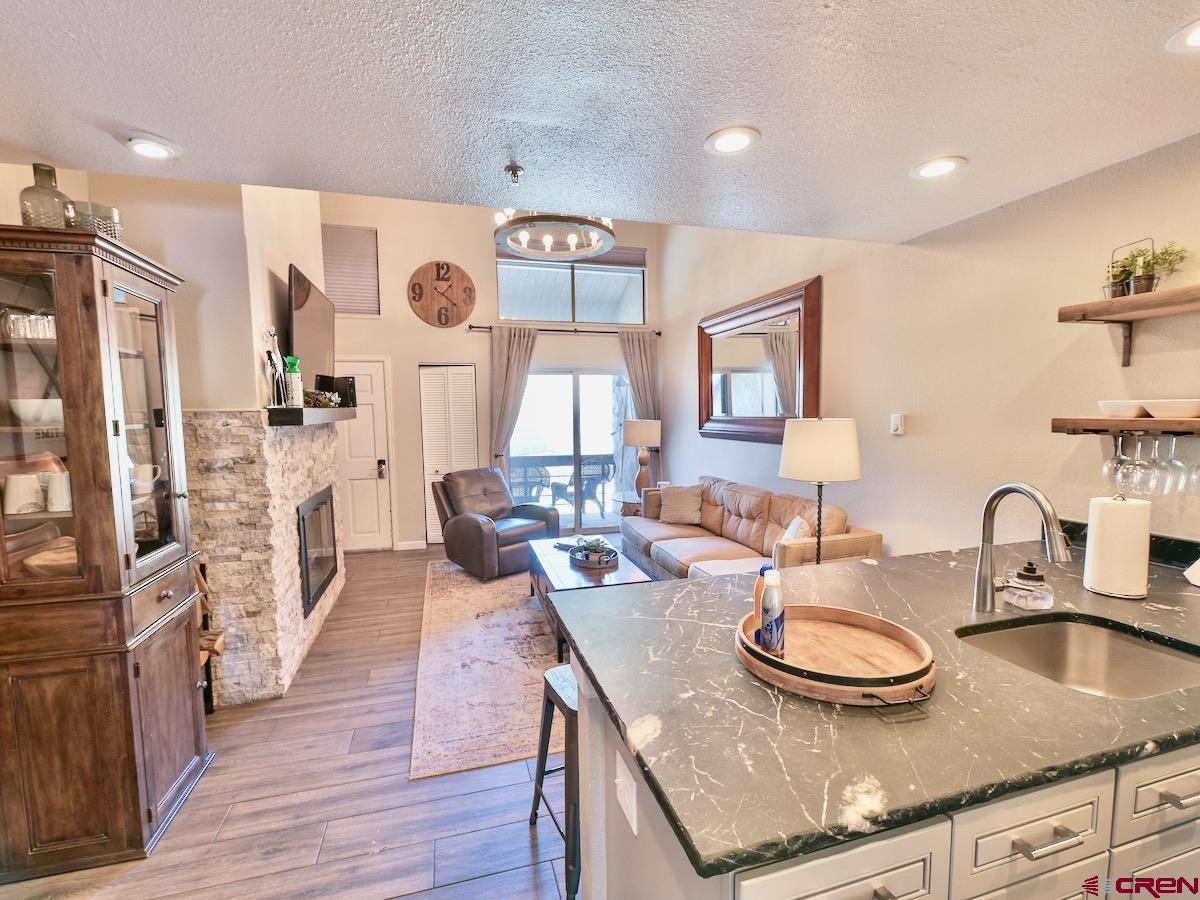 a kitchen with sink refrigerator and dining table