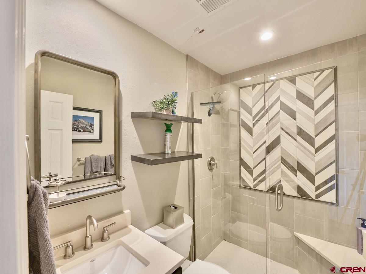 12 Snowmass Road, Unit AXTEL #415 Crested Butte, CO 81225 - Photo 11 of 35 a bathroom with a toilet sink and tub