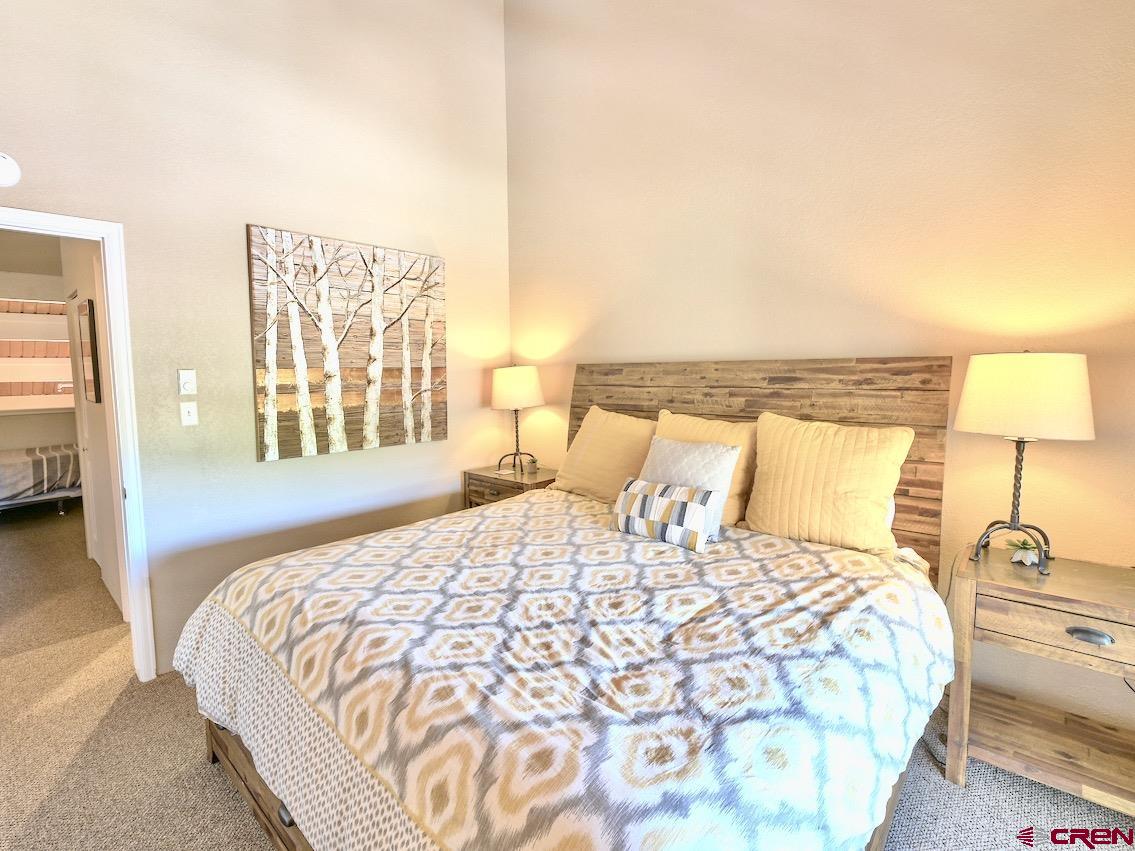 12 Snowmass Road, Unit AXTEL #415 Crested Butte, CO 81225 - Photo 21 of 35 a bedroom with a bed and a night stand