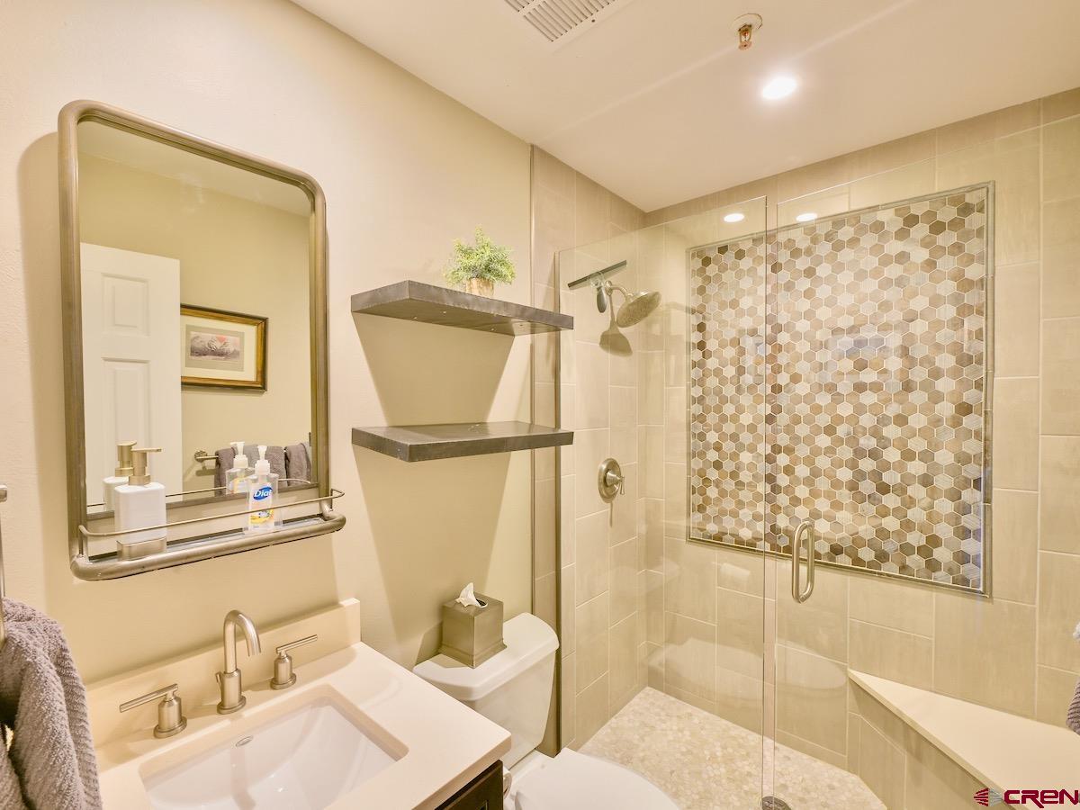 12 Snowmass Road, Unit AXTEL #415 Crested Butte, CO 81225 - Photo 23 of 35 a bathroom with a sink toilet and shower