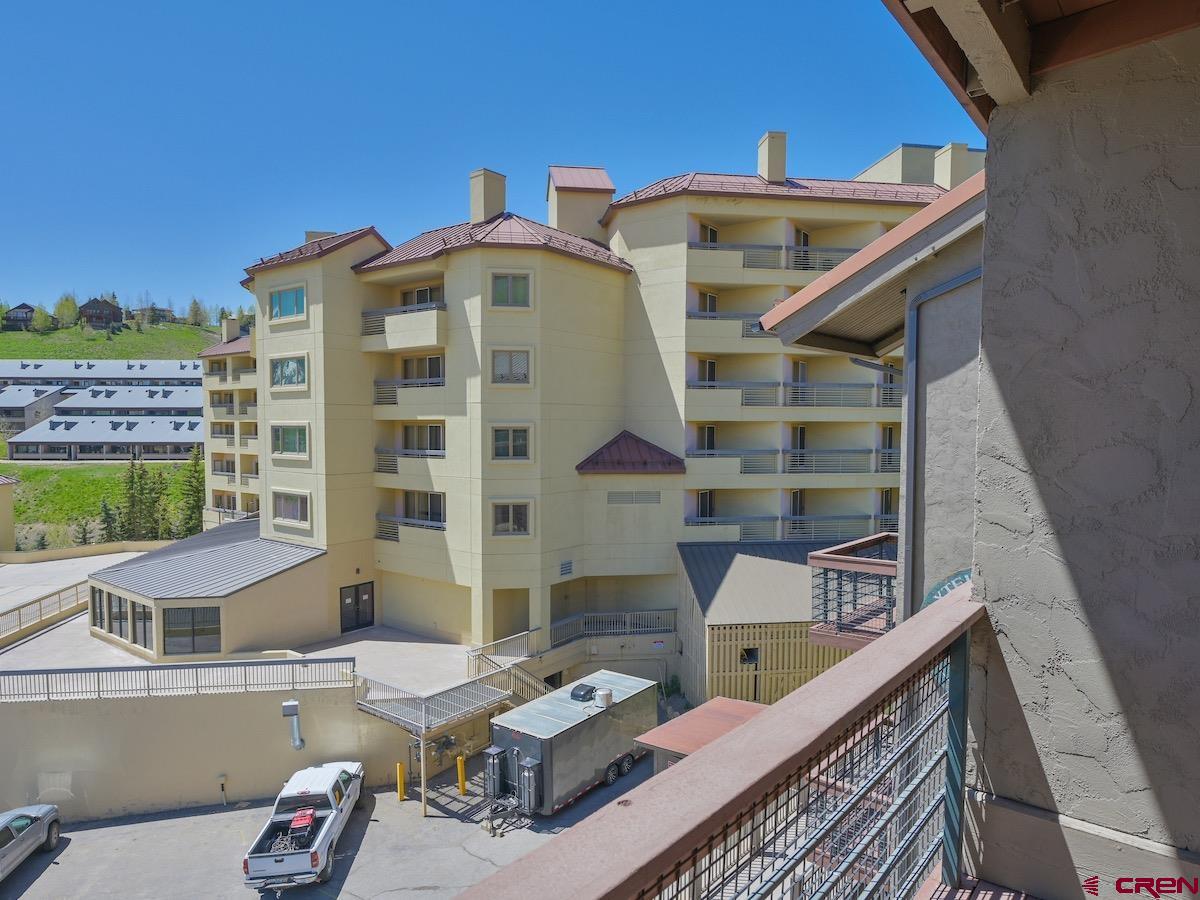 12 Snowmass Road, Unit AXTEL #415 Crested Butte, CO 81225 - Photo 29 of 35 a front view of a house with outdoor seating