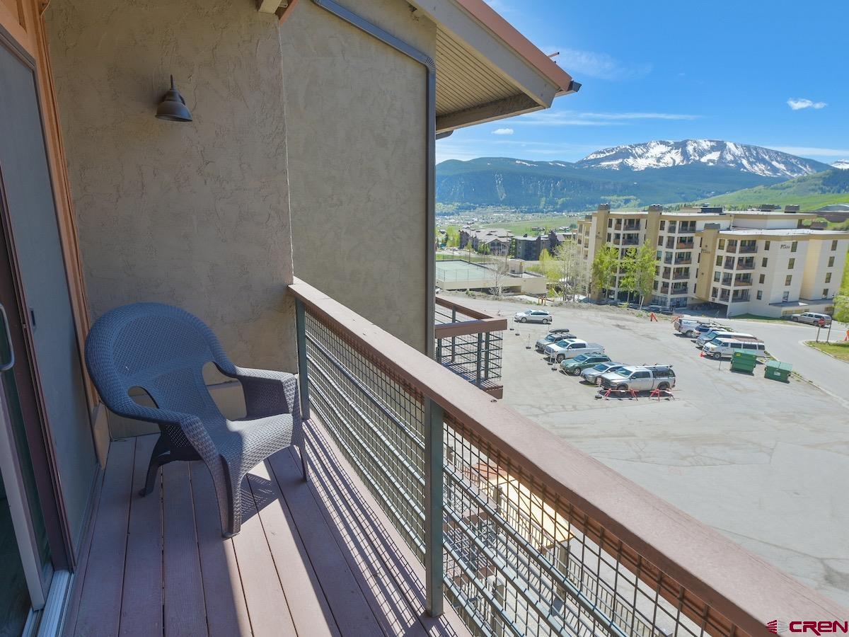 12 Snowmass Road, Unit AXTEL #415 Crested Butte, CO 81225 - Photo 30 of 35 a view of balcony with wooden floor and outdoor seating