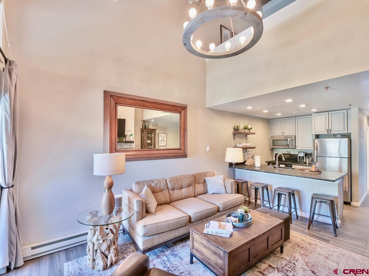 12 Snowmass Road, Unit AXTEL #415 Crested Butte, CO 81225 - Photo 3 of 35 a living room with furniture a rug and kitchen view