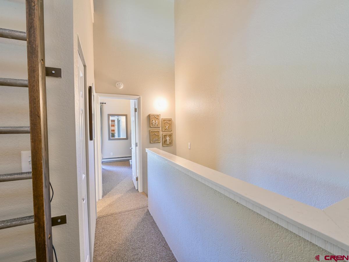 12 Snowmass Road, Unit AXTEL #415 Crested Butte, CO 81225 - Photo 7 of 35 a view of hallway with bathroom and white walls