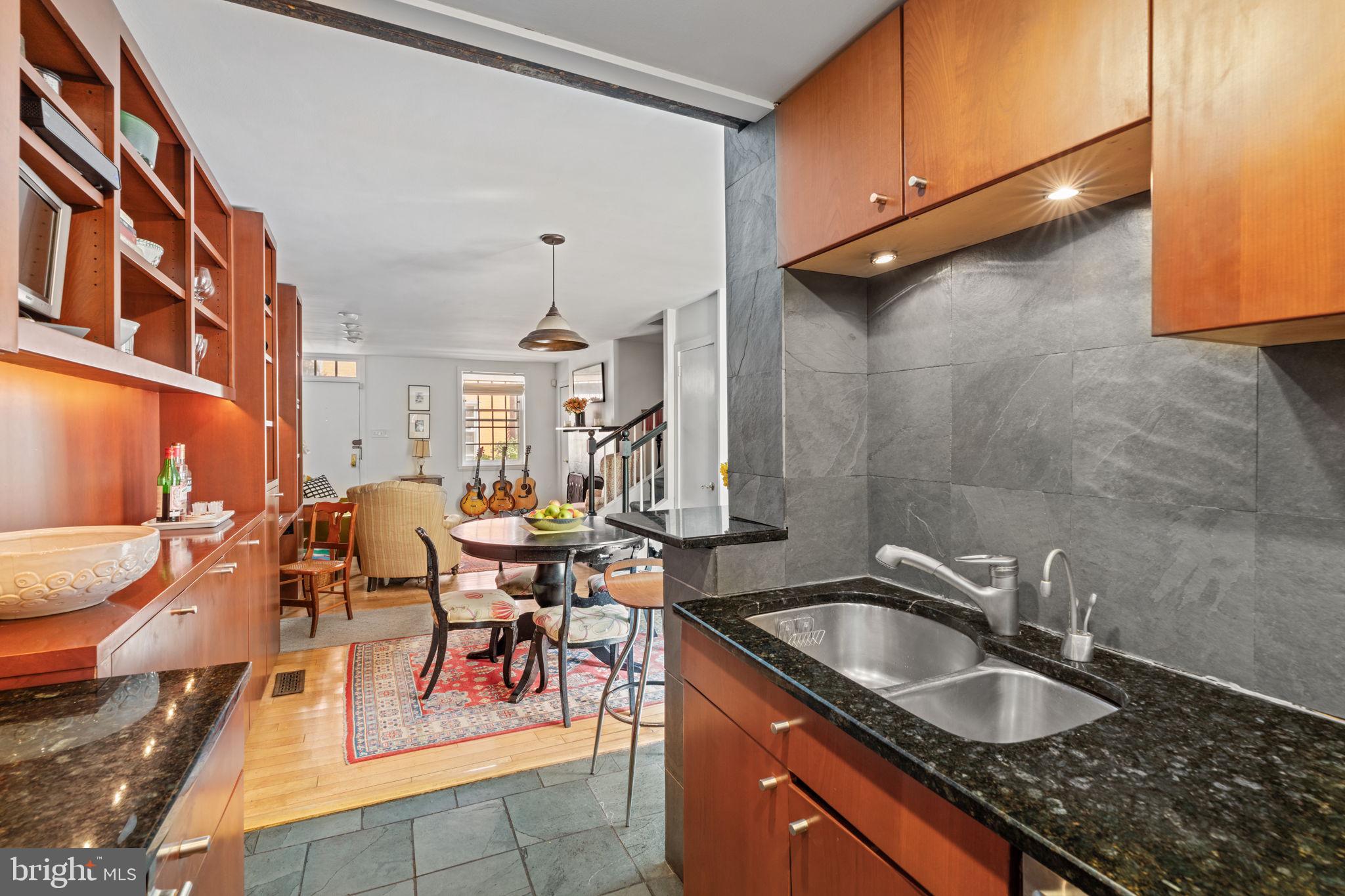 2410 Panama Street Philadelphia, PA 19103 - Photo 13 of 50 a kitchen with granite countertop a sink a counter top space and cabinets