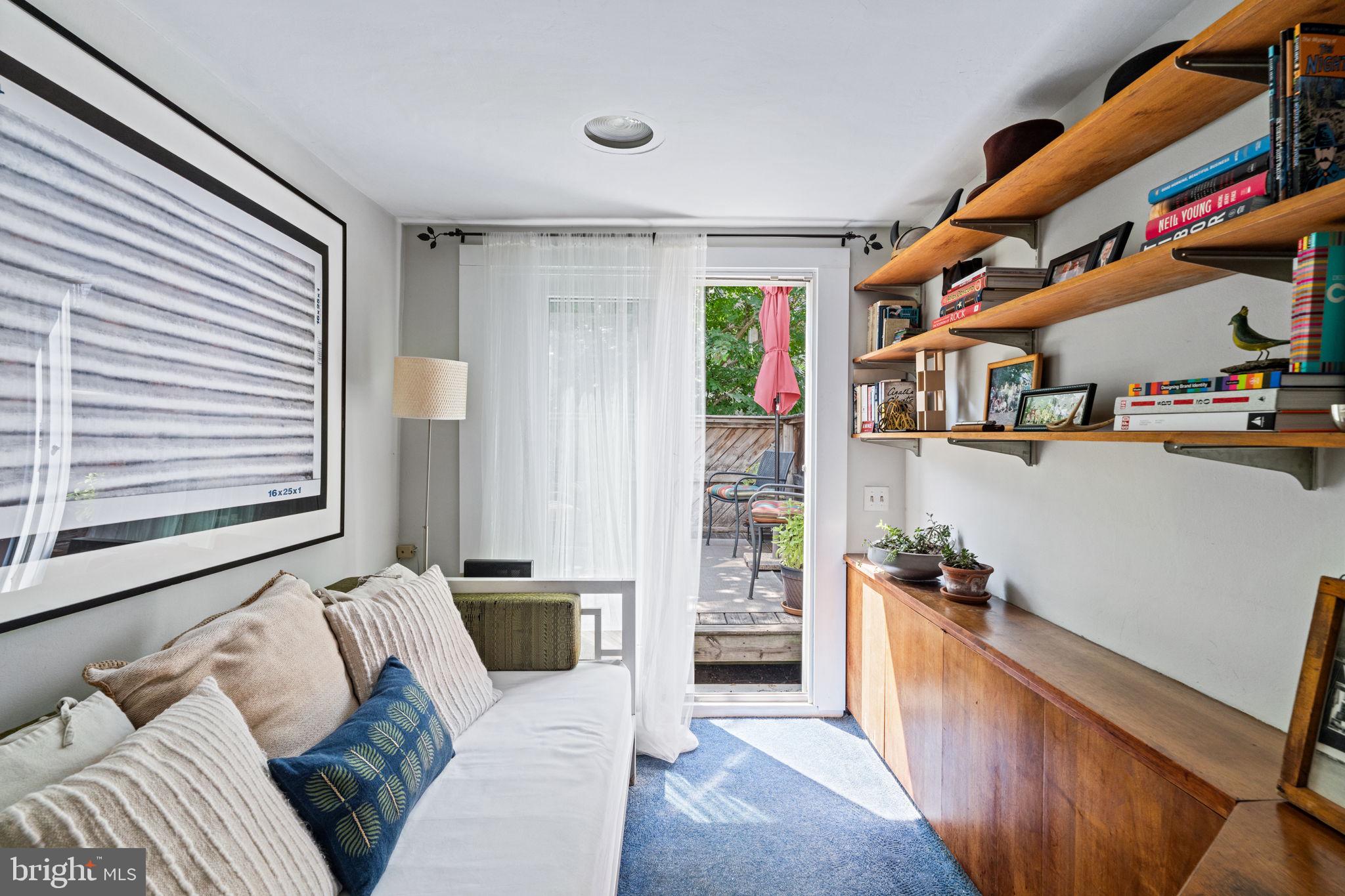 2410 Panama Street Philadelphia, PA 19103 - Photo 31 of 50 a living room with furniture and a book shelf