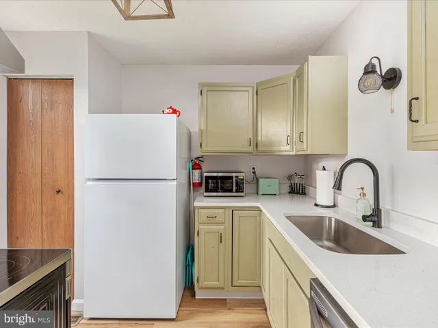 a kitchen with stainless steel appliances granite countertop a sink and cabinets