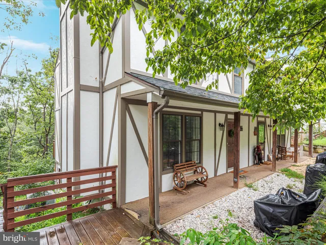 a view of a patio with table and chairs and potted plants