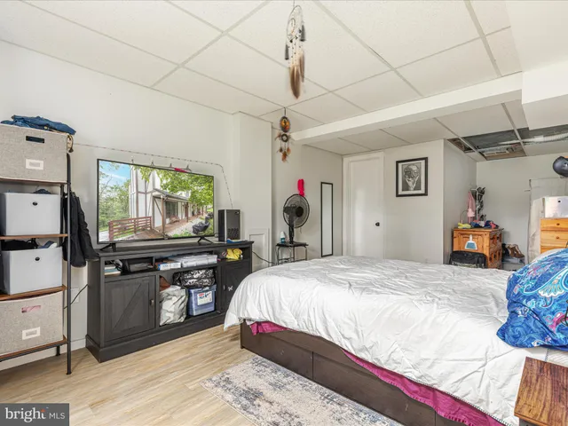 a spacious bedroom with a bed a desk and chair