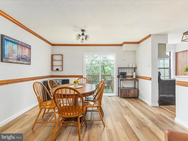 a dining room with furniture and wooden floor