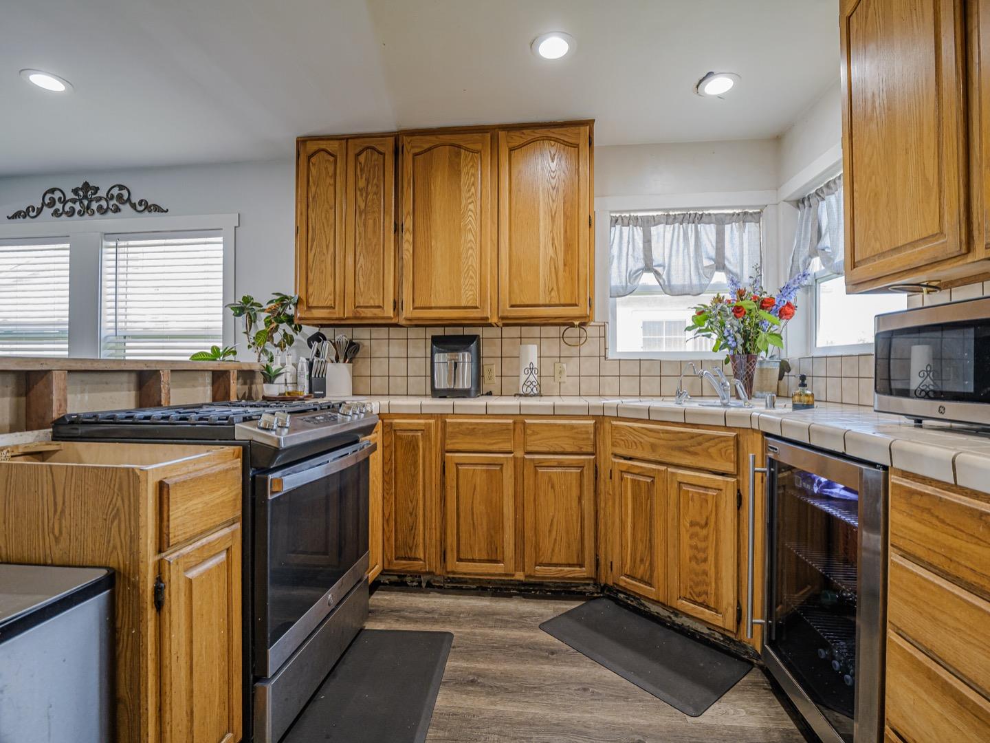 27 Burchell Avenue Watsonville, CA 95076 - Photo 11 of 27 a kitchen with stainless steel appliances granite countertop a sink stove and refrigerator