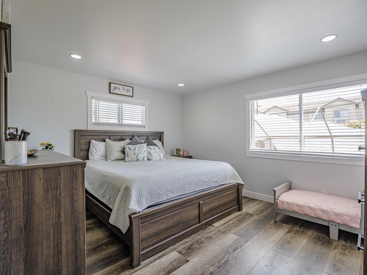 27 Burchell Avenue Watsonville, CA 95076 - Photo 17 of 27 a bedroom with a bed and wooden floor