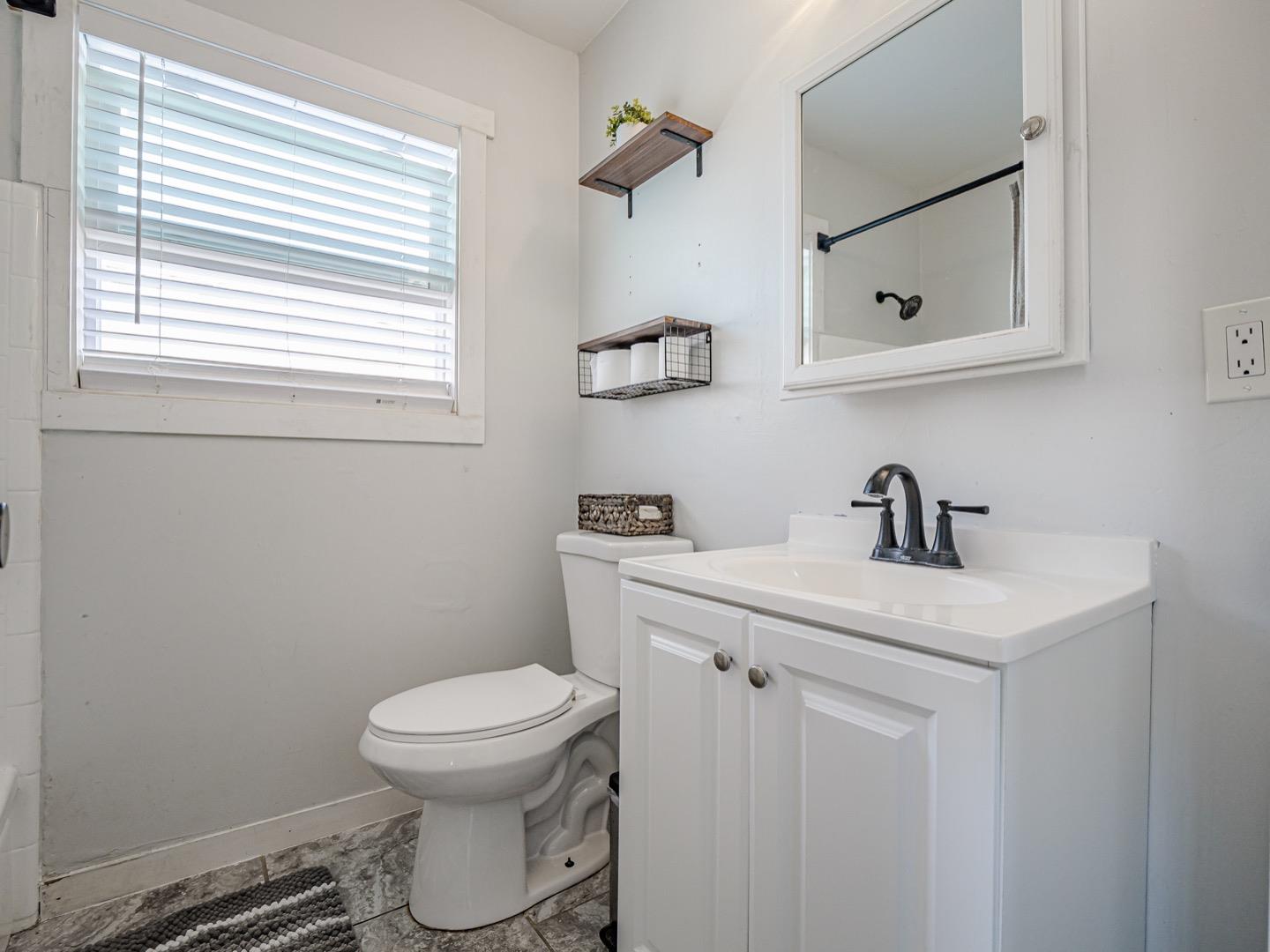 27 Burchell Avenue Watsonville, CA 95076 - Photo 18 of 27 a bathroom with a toilet a sink and mirror