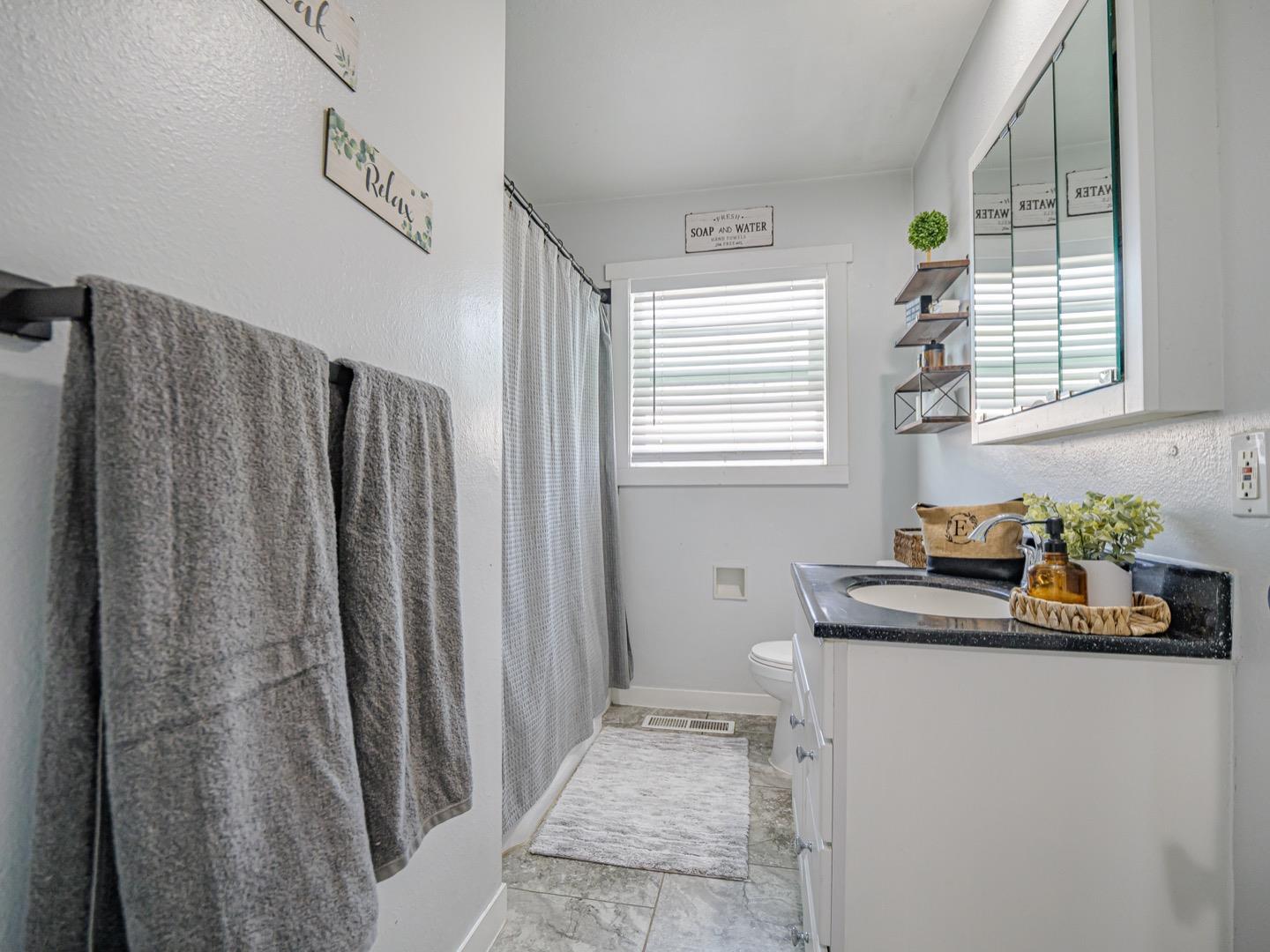27 Burchell Avenue Watsonville, CA 95076 - Photo 20 of 27 a bathroom with a sink a mirror and a shower