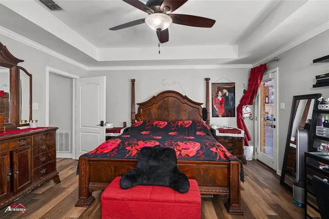 a bedroom with a bed and a flat screen tv