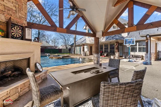 a living room with furniture a fireplace and a floor to ceiling window