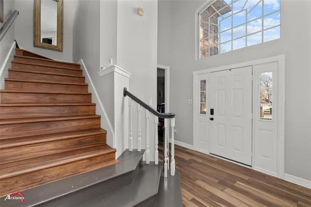 a view of entryway with wooden floor and stairs