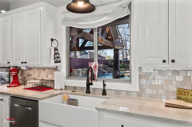 a kitchen that has a sink and a stove