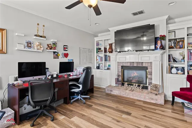 a view of a workspace with furniture and a window