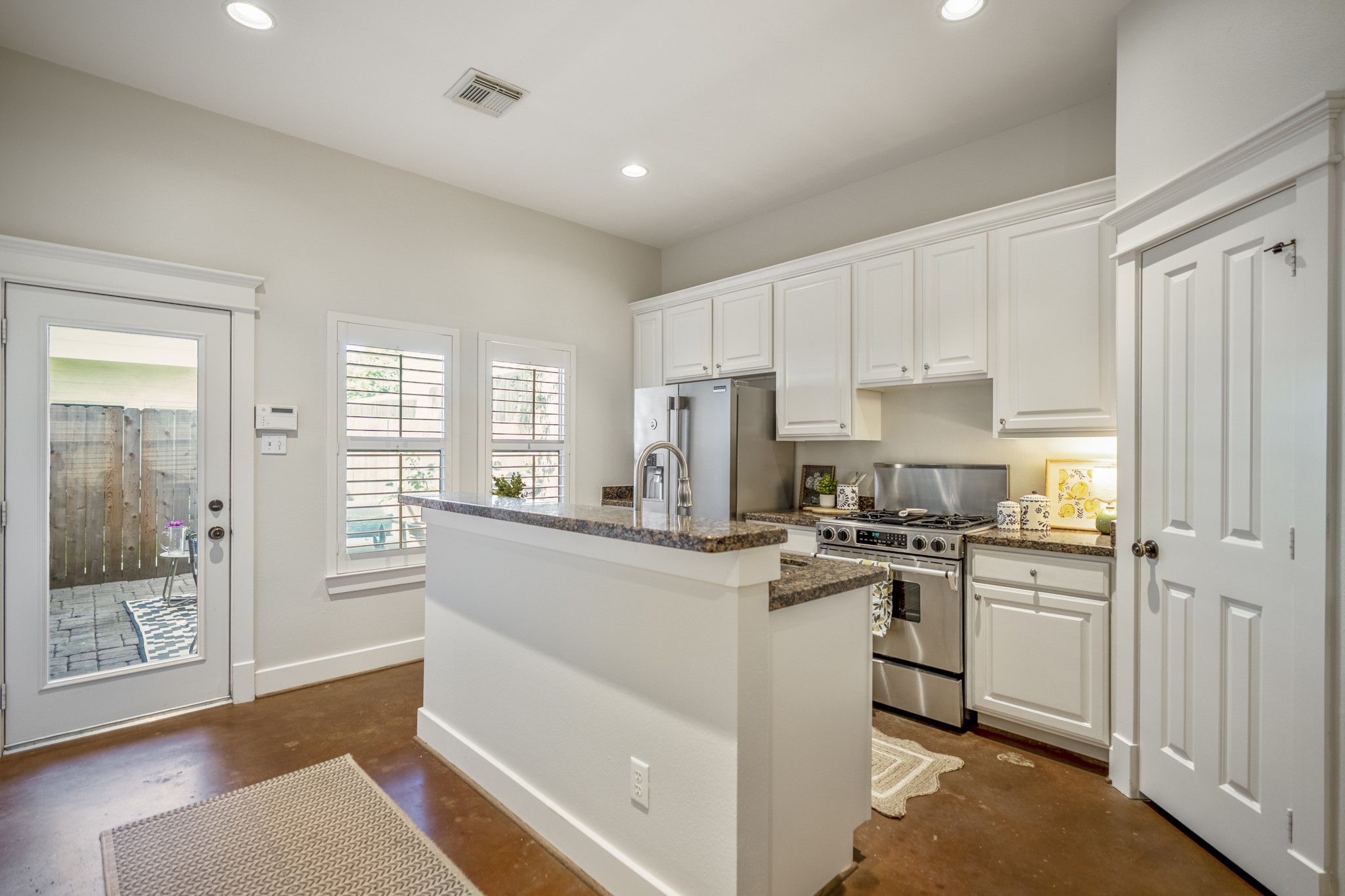 905 West 23rd Street Houston, TX 77008 - Photo 14 of 46 Functional layout with pantry storage and open flow to both living spaces and backyard patio.