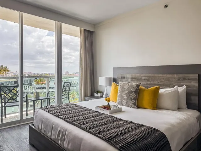 a bedroom with a large bed and a large window