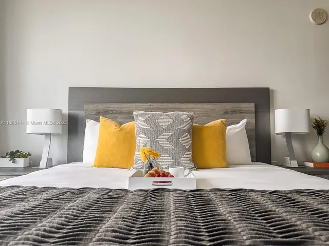 a bedroom with a bed and lamp