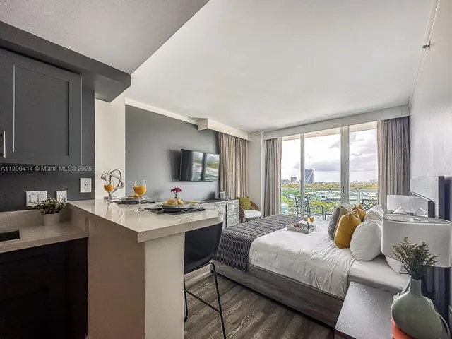 a bedroom with a bed and a large window