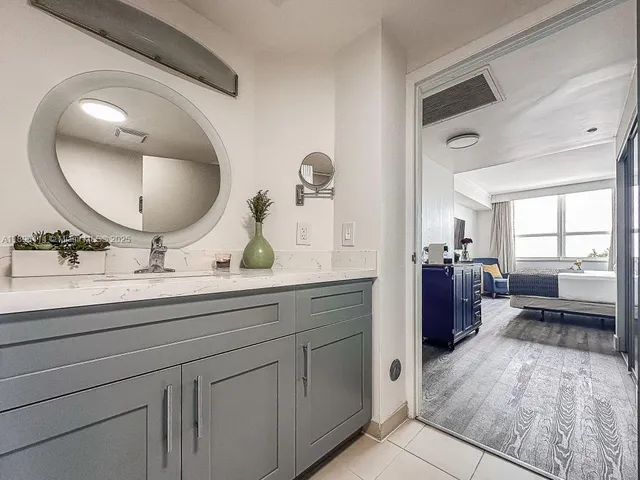 a bathroom with a double vanity sink and a mirror