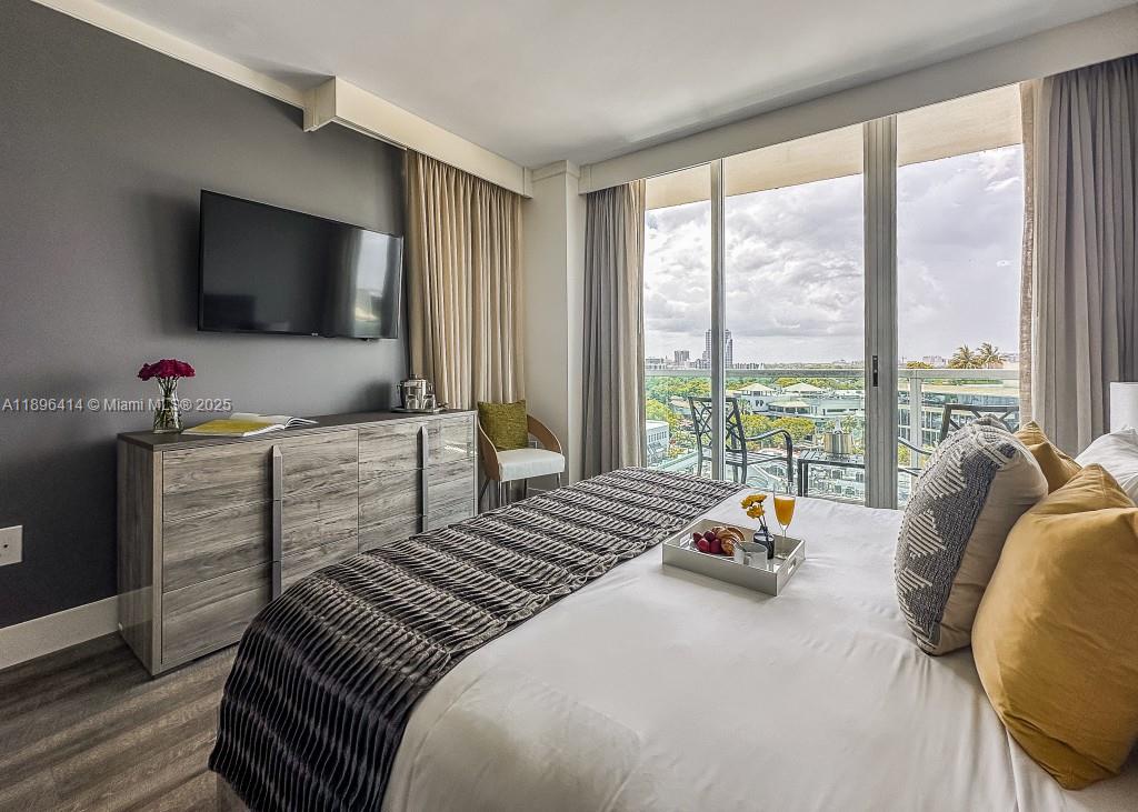 2889 McFarlane Road, Unit 912 Miami, FL 33133 - Photo 9 of 20 a bedroom with a bed and large windows